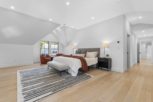 bedroom featuring vaulted ceiling and light wood-type flooring