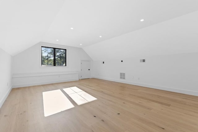 bonus room with vaulted ceiling and light hardwood / wood-style floors