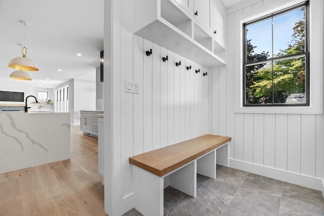 mudroom featuring sink and light hardwood / wood-style floors