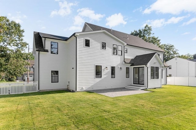 rear view of property featuring a yard and a patio area