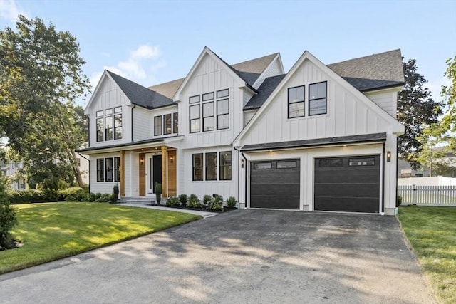 modern farmhouse style home featuring a garage and a front yard