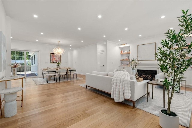 1 Cole Rd, Wayland, MA 01778 - living room with crown molding, light wood finished floors, recessed lighting, a chandelier, and a glass covered fireplace