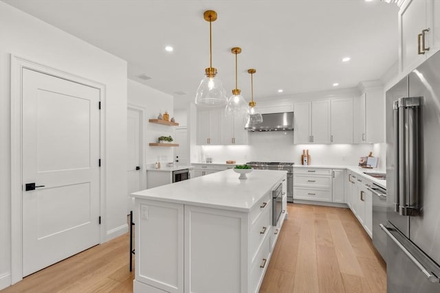 1 Cole Rd, Wayland, MA 01778 - kitchen with premium appliances, wall chimney exhaust hood, a center island, white cabinetry, and open shelves