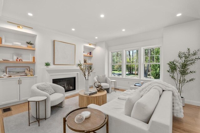 1 Cole Rd, Wayland, MA 01778 - living area featuring light wood finished floors, a glass covered fireplace, recessed lighting, and baseboards