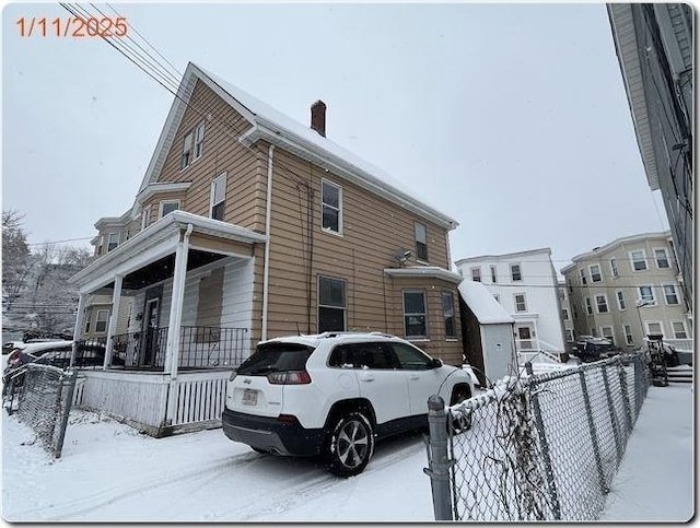 view of snowy exterior with a porch