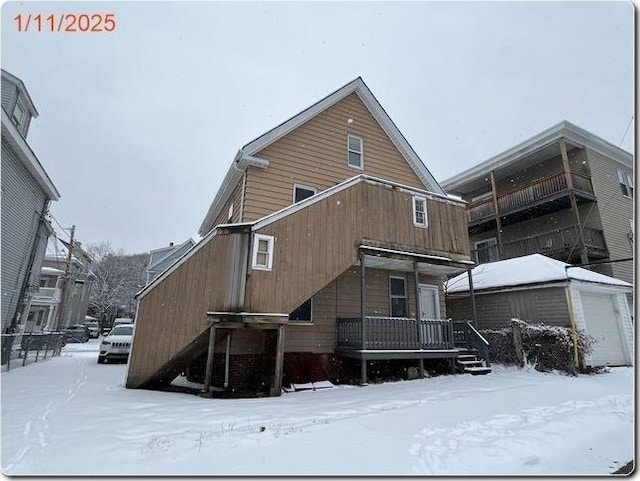 view of snow covered rear of property