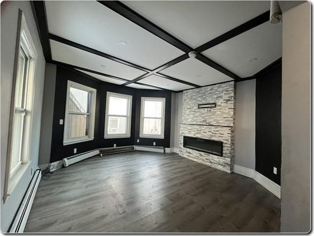 unfurnished living room featuring a stone fireplace, dark hardwood / wood-style floors, beamed ceiling, coffered ceiling, and a baseboard heating unit