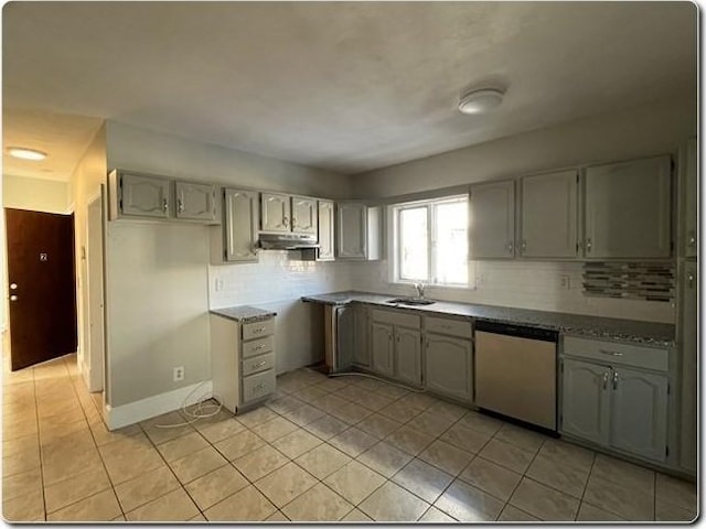 kitchen with gray cabinets, light tile patterned flooring, dishwasher, sink, and decorative backsplash