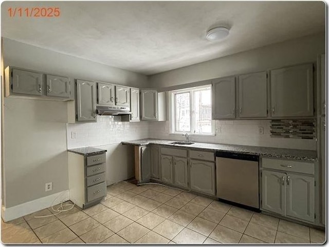 kitchen featuring light tile patterned flooring, sink, gray cabinets, dishwasher, and decorative backsplash