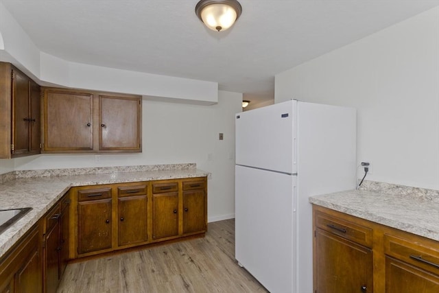 kitchen with white fridge and light wood-type flooring