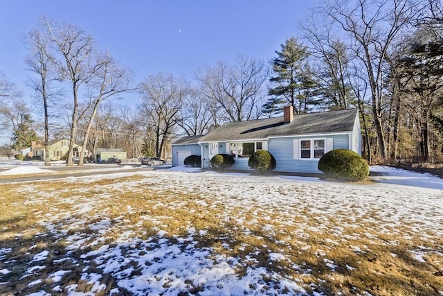 view of snowy exterior with a garage