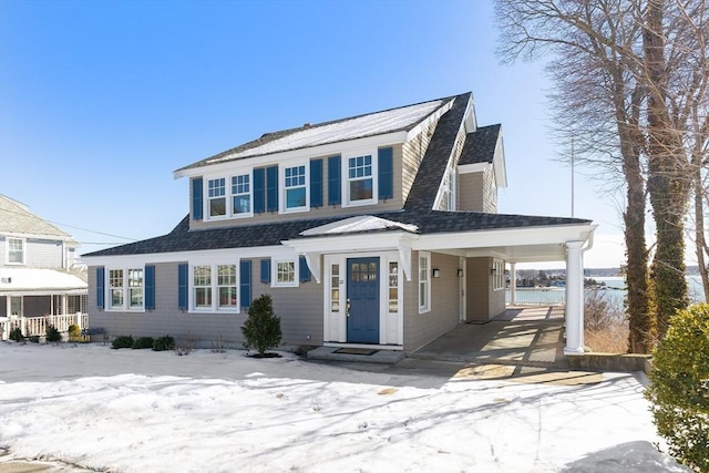 view of front of home featuring driveway, a shingled roof, and a carport