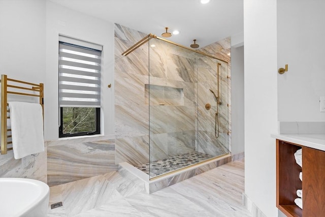 bathroom featuring a shower stall, a freestanding bath, and tile walls