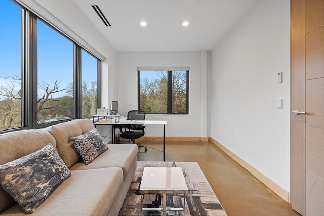 home office featuring recessed lighting, finished concrete flooring, and baseboards