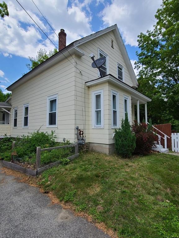 view of home's exterior with a lawn