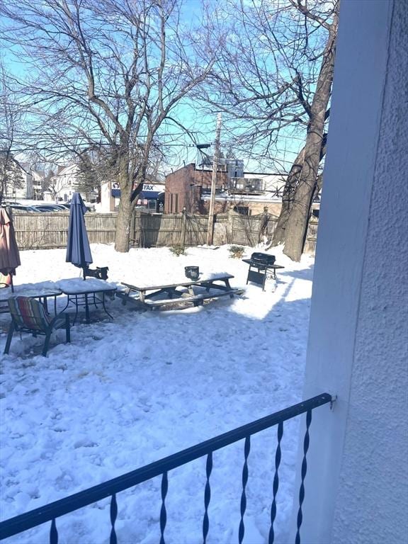 yard layered in snow with fence