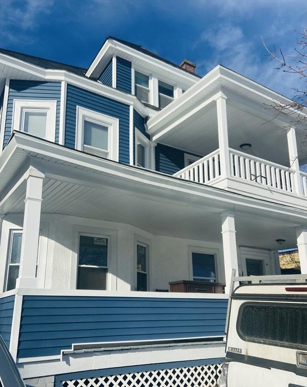 view of property exterior featuring a porch and a balcony