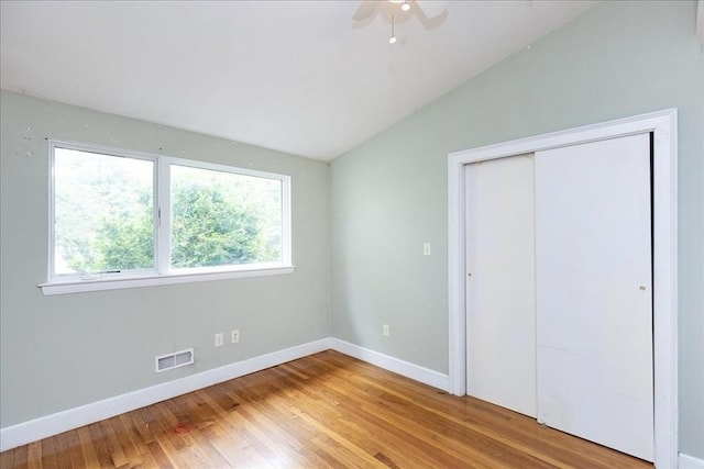 68 Walnut Rd, Swampscott, MA 01907 - unfurnished bedroom with lofted ceiling, hardwood / wood-style floors, baseboards, a closet, and ceiling fan