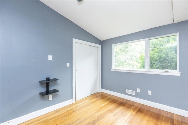 68 Walnut Rd, Swampscott, MA 01907 - unfurnished bedroom with lofted ceiling, baseboards, wood-type flooring, and a closet