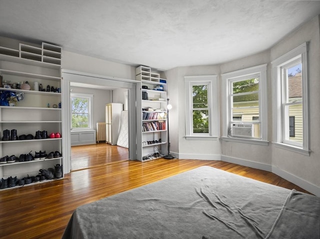 4 Darling St, Worcester, MA 01605 - bedroom featuring wood finished floors, baseboards, freestanding refrigerator, and cooling unit