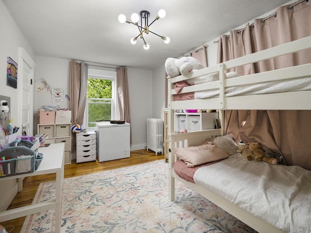 4 Darling St, Worcester, MA 01605 - bedroom featuring radiator, wood finished floors, a chandelier, and fridge