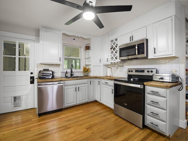 4 Darling St, Worcester, MA 01605 - kitchen featuring stainless steel appliances, a sink, wooden counters, and white cabinets