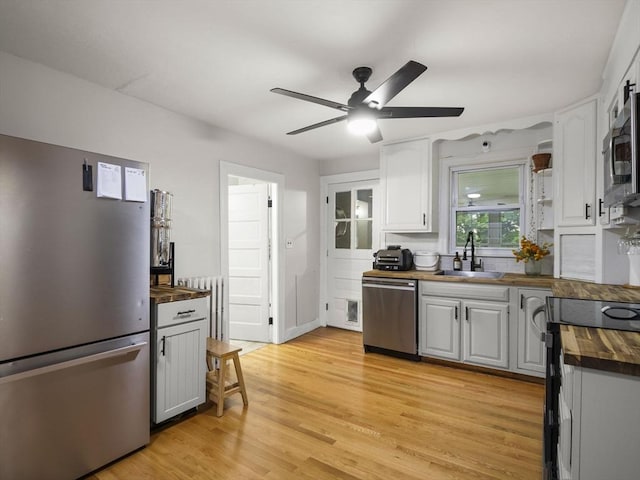 4 Darling St, Worcester, MA 01605 - kitchen with stainless steel appliances, butcher block counters, a sink, a ceiling fan, and light wood-style flooring