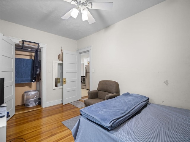 4 Darling St, Worcester, MA 01605 - bedroom with freestanding refrigerator, light wood-style floors, a ceiling fan, and baseboards