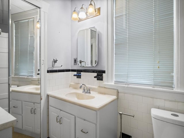 4 Darling St, Worcester, MA 01605 - bathroom with tile walls, vanity, toilet, and a wainscoted wall