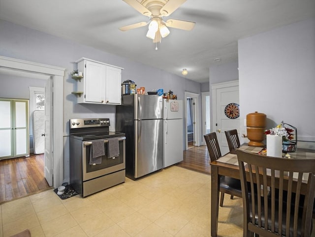4 Darling St, Worcester, MA 01605 - kitchen with stainless steel appliances, white cabinets, a ceiling fan, and light flooring