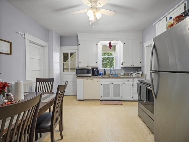 4 Darling St, Worcester, MA 01605 - kitchen featuring appliances with stainless steel finishes, a sink, white cabinets, and ceiling fan
