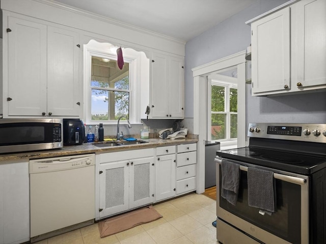 4 Darling St, Worcester, MA 01605 - kitchen with stainless steel appliances, a sink, plenty of natural light, and white cabinetry