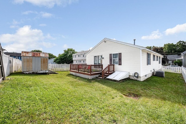 33 Hopkins St, Dracut, MA 01826 - back of house with a deck, a storage unit, and a fenced backyard