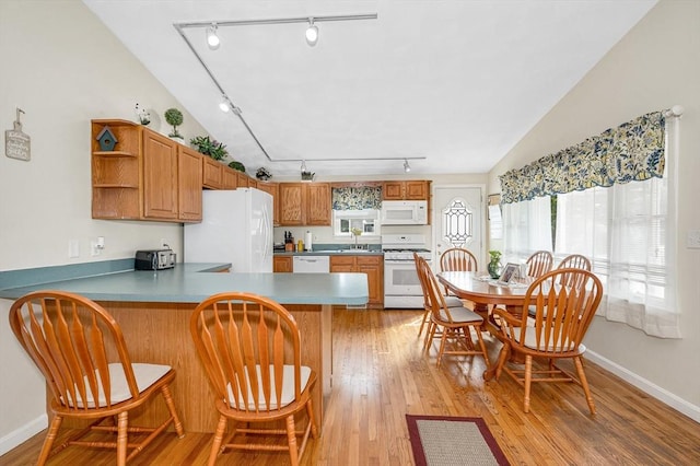 33 Hopkins St, Dracut, MA 01826 - kitchen with rail lighting, white appliances, open shelves, a peninsula, and light wood finished floors