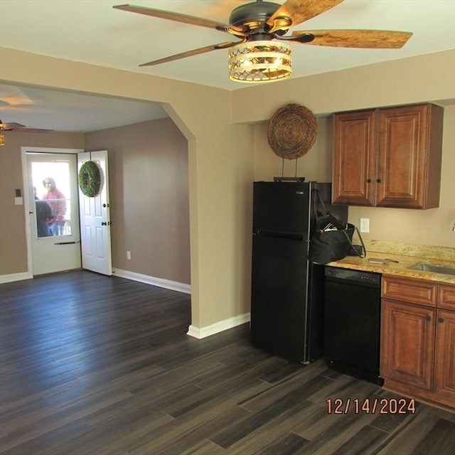 kitchen featuring black appliances, dark hardwood / wood-style flooring, and sink