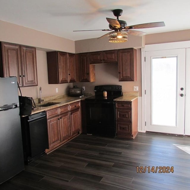 kitchen featuring black appliances, dark hardwood / wood-style floors, ceiling fan, and sink