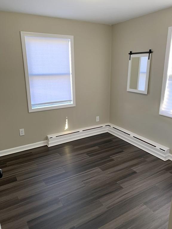 empty room featuring dark hardwood / wood-style floors