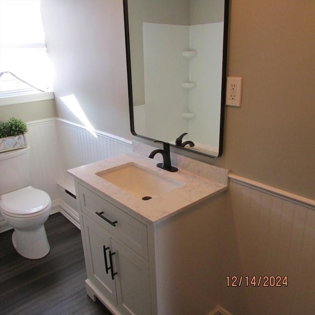 bathroom featuring vanity, toilet, and wood-type flooring