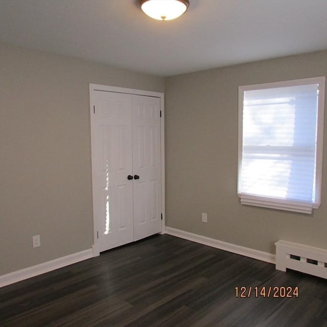 spare room featuring dark hardwood / wood-style flooring