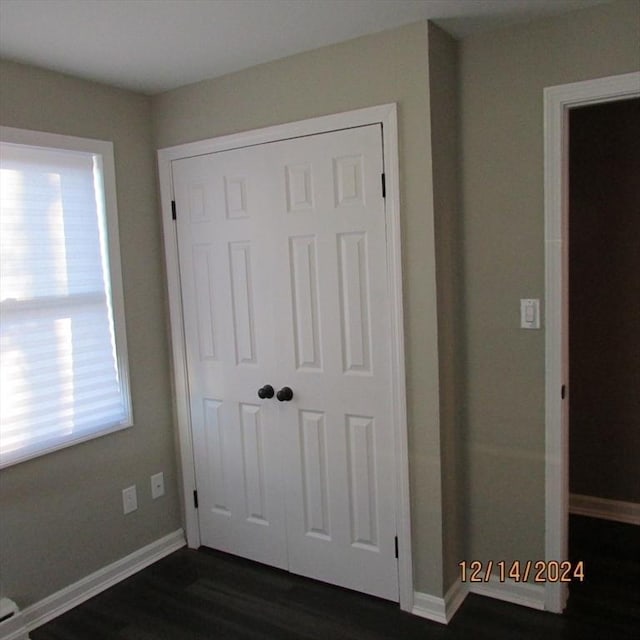 interior space featuring a closet and dark hardwood / wood-style flooring