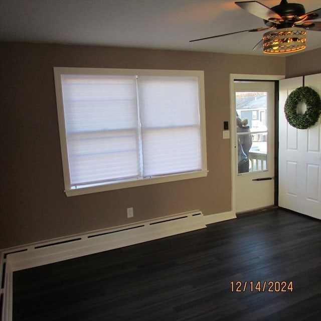 entryway with baseboard heating, dark wood-type flooring, and ceiling fan