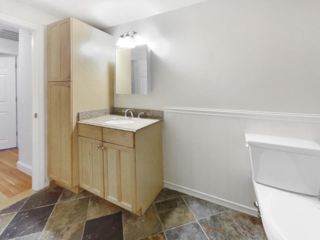 bathroom with toilet and vanity