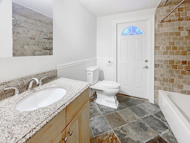 full bathroom featuring toilet, vanity, and bathing tub / shower combination