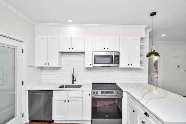 kitchen with decorative light fixtures, stainless steel appliances, white cabinetry, and sink