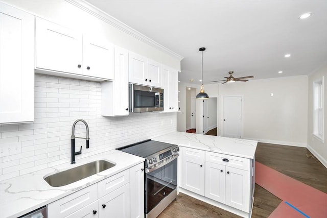 kitchen with stainless steel appliances, dark wood-type flooring, sink, decorative light fixtures, and white cabinetry