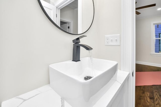 bathroom with wood-type flooring, vanity, and ceiling fan