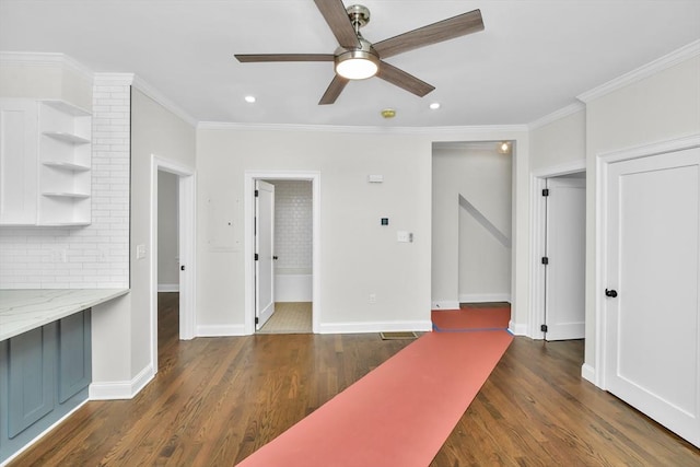 unfurnished living room with ceiling fan, dark hardwood / wood-style floors, and ornamental molding