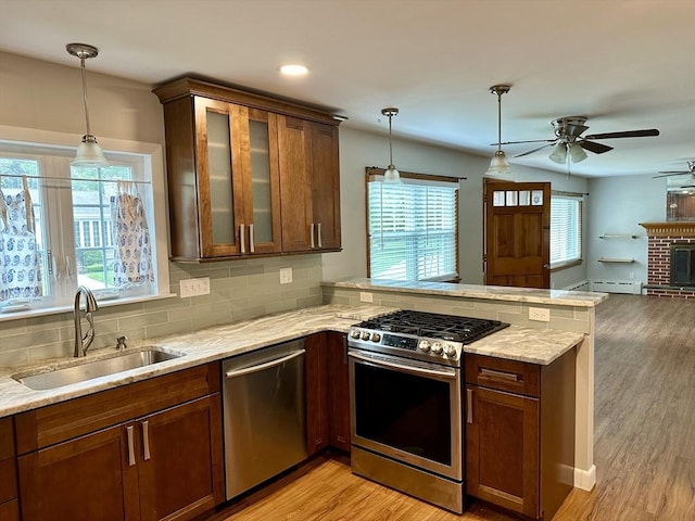 15 Evans, Somerset, MA 02726 - kitchen featuring appliances with stainless steel finishes, a peninsula, a ceiling fan, light wood-style flooring, and backsplash