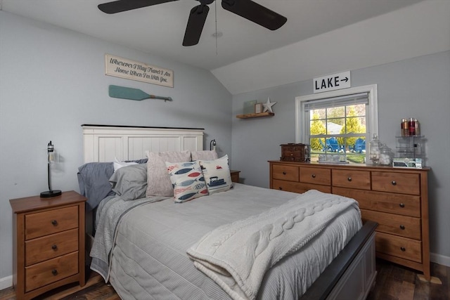 bedroom with dark wood-type flooring, lofted ceiling, baseboards, and a ceiling fan