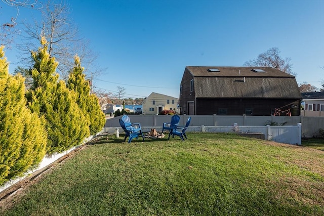 view of yard featuring an outdoor fire pit and fence